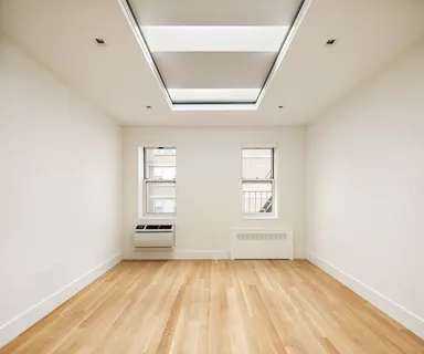 a kitchen with stainless steel appliances a stove and white cabinets