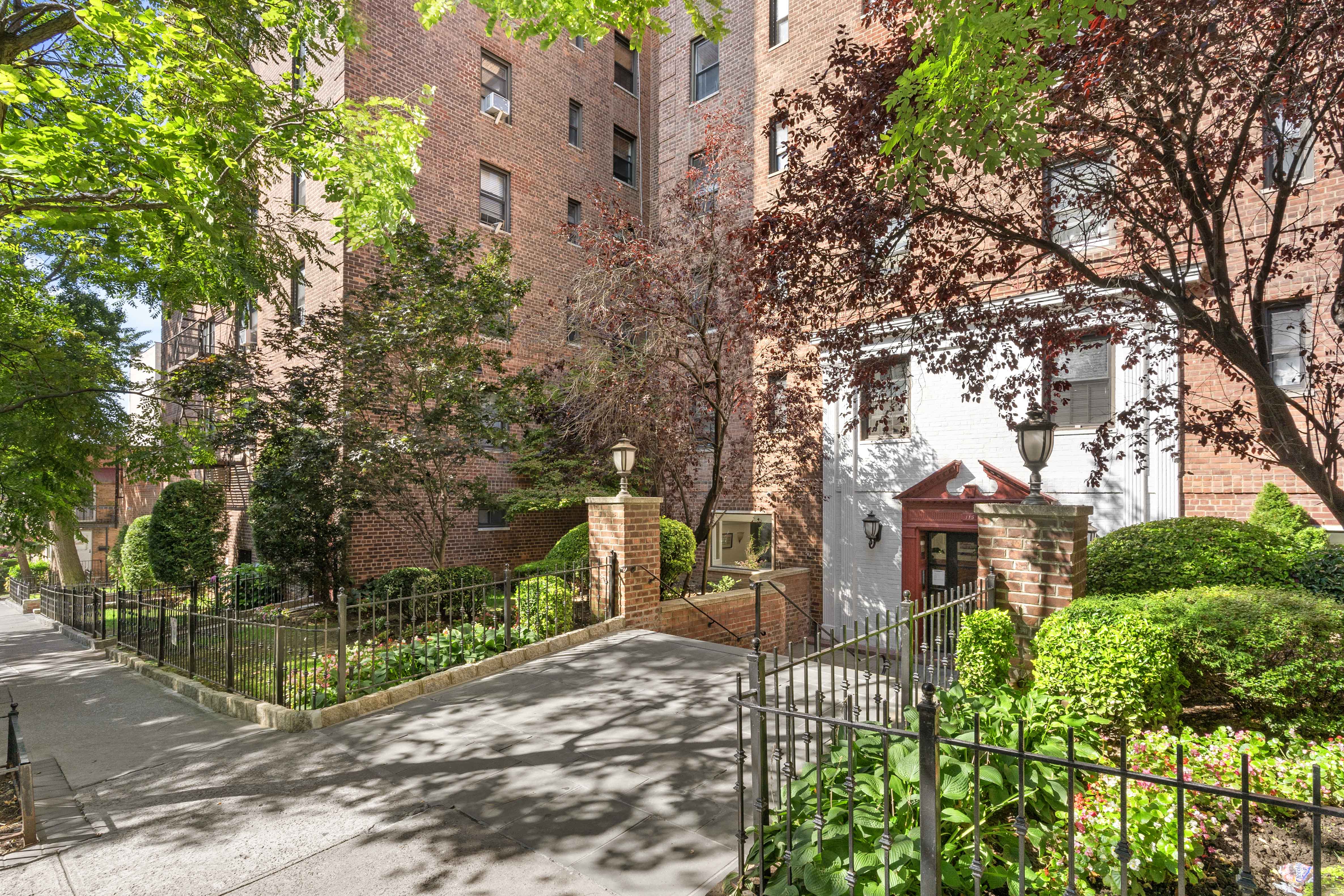145 72nd Street, Unit F7 Brooklyn, NY 11209 - Photo 8 of 9 a front view of a house with a yard