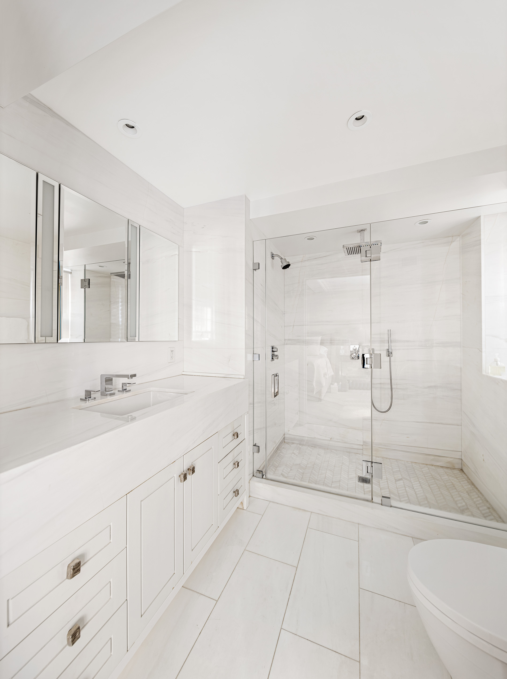 12 East 88th Street, Unit 2D Manhattan, NY 10128 - Photo 5 of 15 a bathroom with a granite countertop sink mirror and vanity