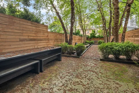a bench is sitting in the middle of a yard