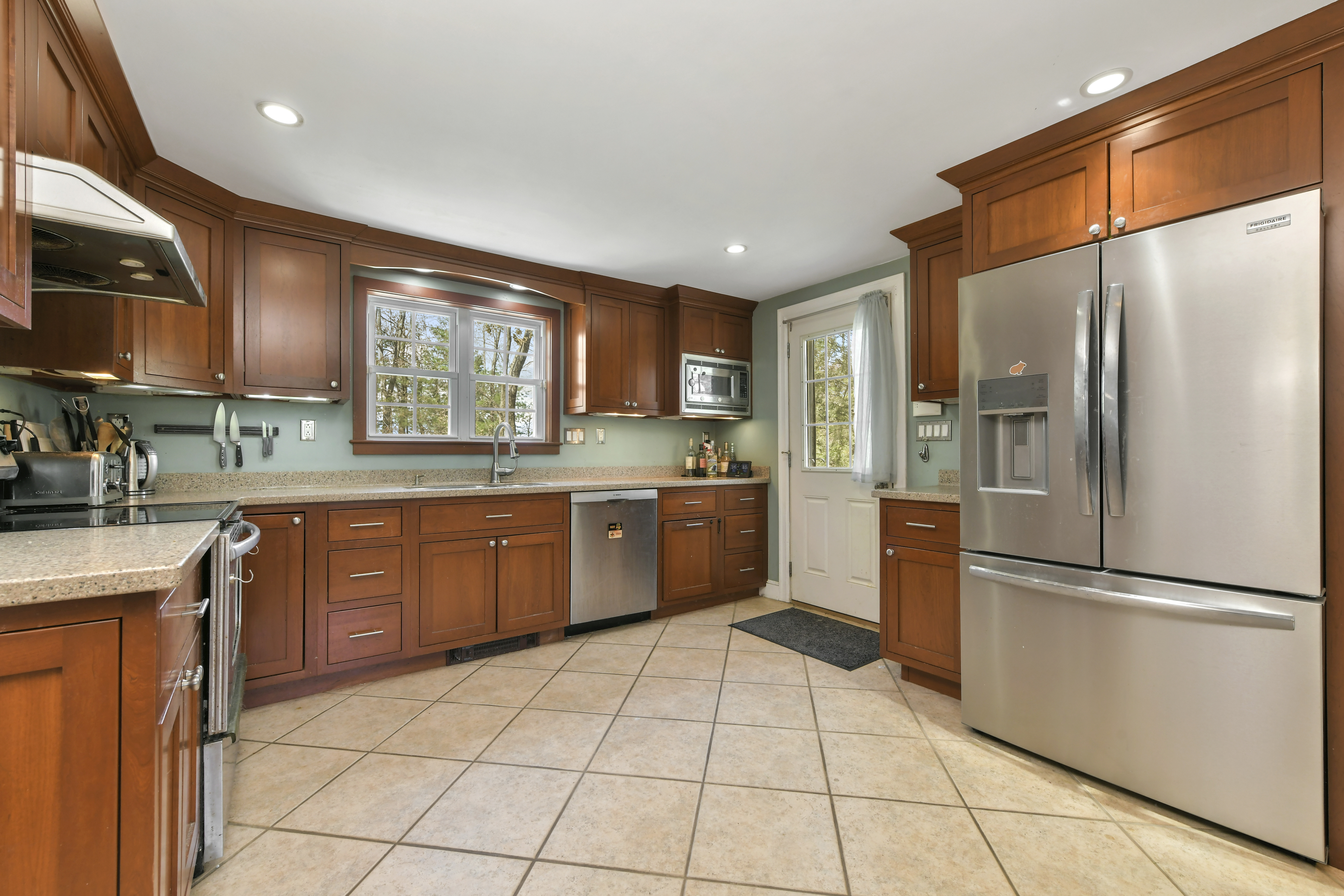 50 Rustic Road Walpole, MA 02032 - Photo 3 of 16 a kitchen with stainless steel appliances granite countertop a refrigerator sink and cabinets