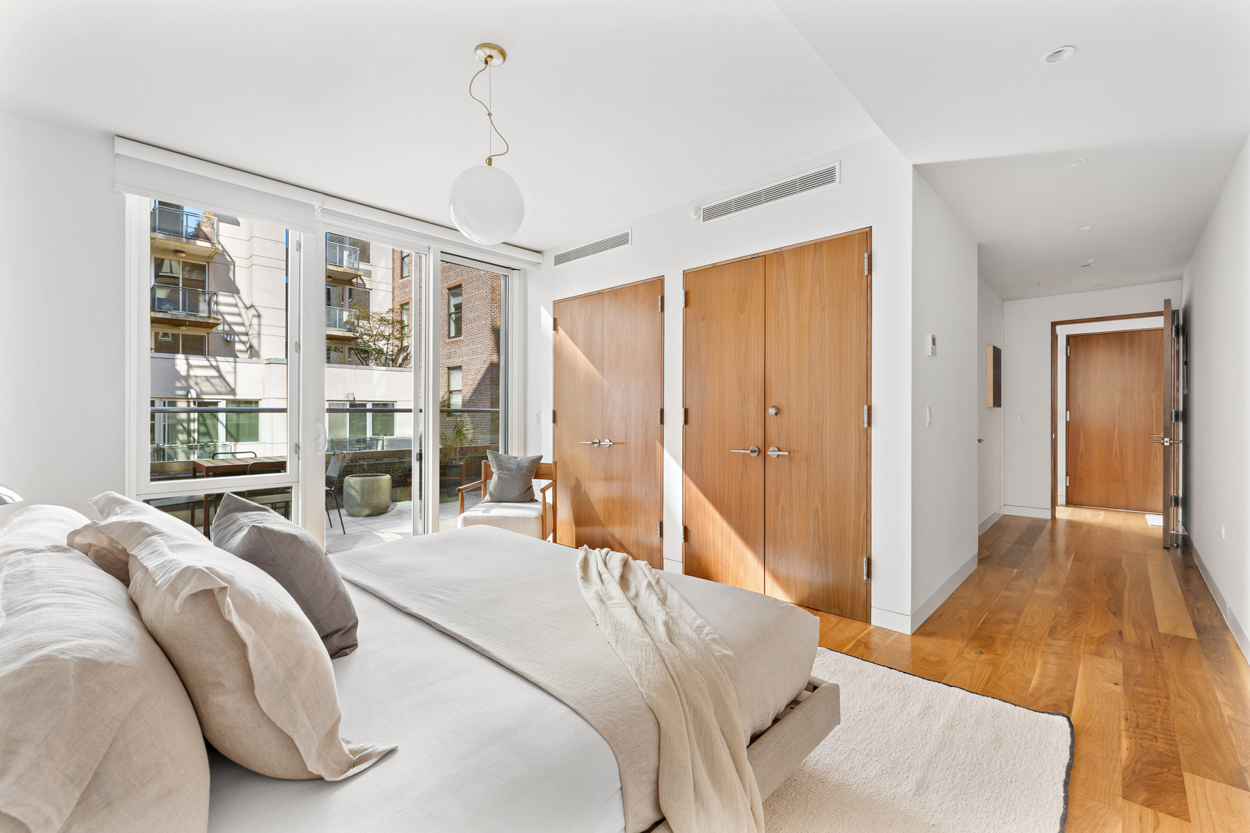 151 West 21st Street, Unit 10A Manhattan, NY 10011 - Photo 19 of 26 a bedroom with a large bed and a large window