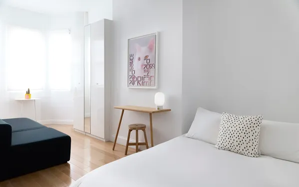 a bedroom with a bed and a couch