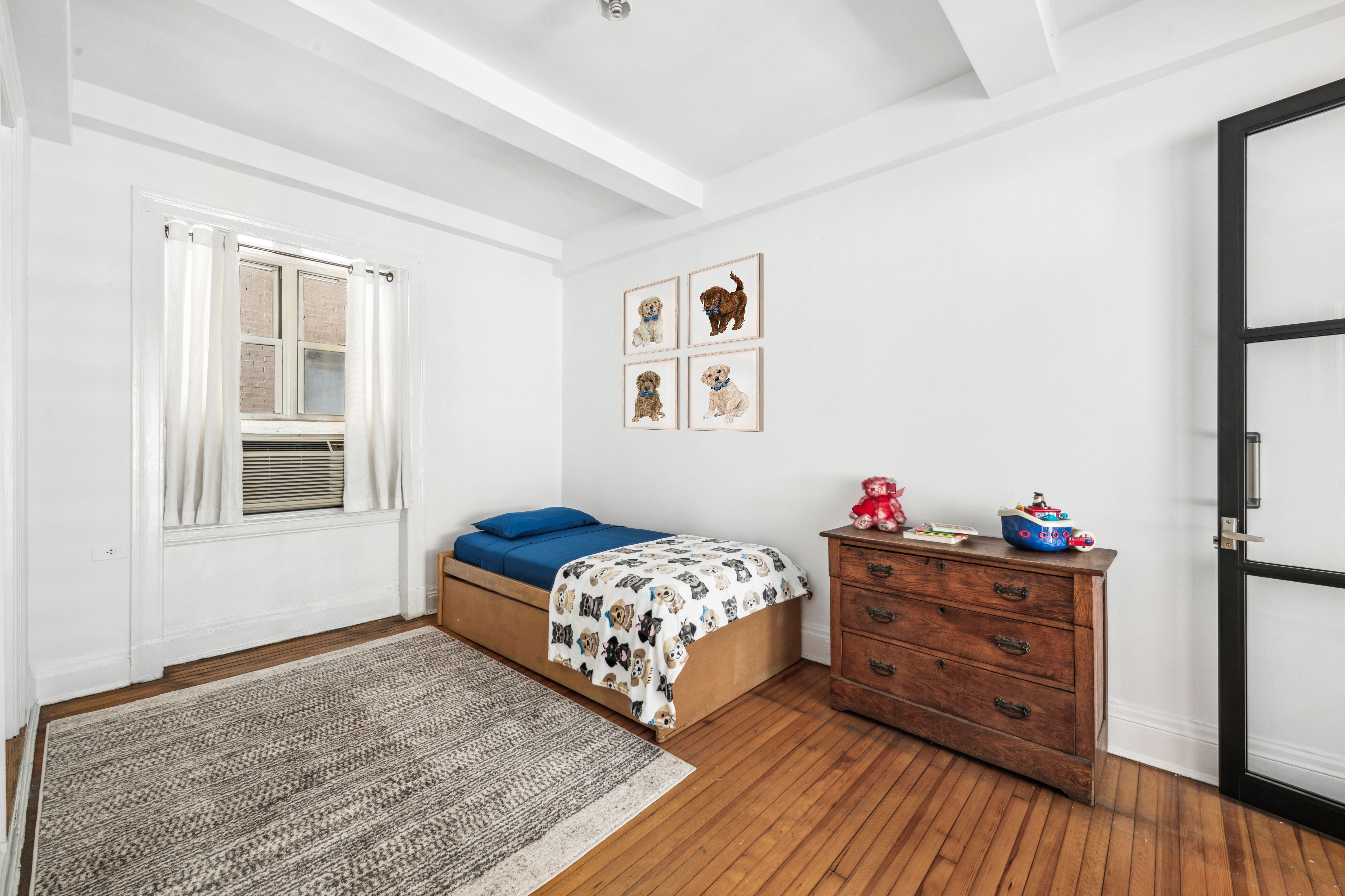 1 West 67th Street, Unit 501/502 Manhattan, NY 10023 - Photo 11 of 19 a bedroom with a bed and wooden floor