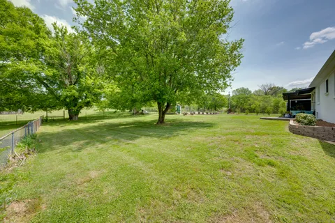 a view of a house with a backyard
