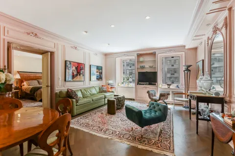 a living room with furniture large window and a flat screen tv