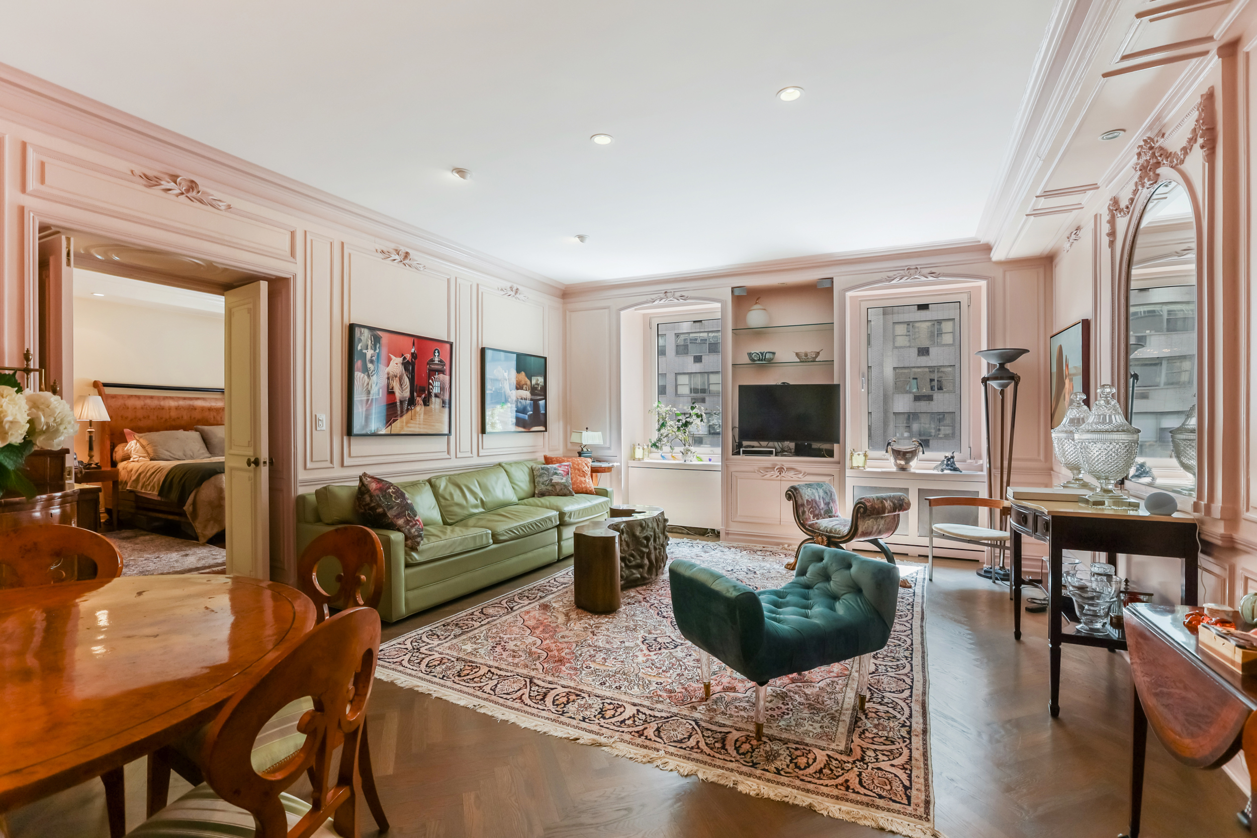 465 Park Avenue, Unit 409 Manhattan, NY 10022 - Photo 1 of 11 a living room with furniture large window and a flat screen tv