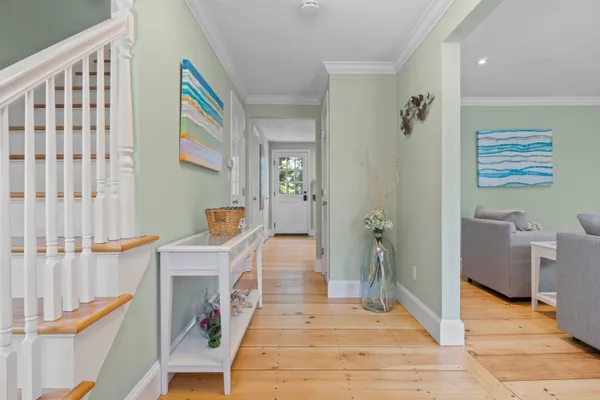 a view of an entryway with wooden floor and a fireplace