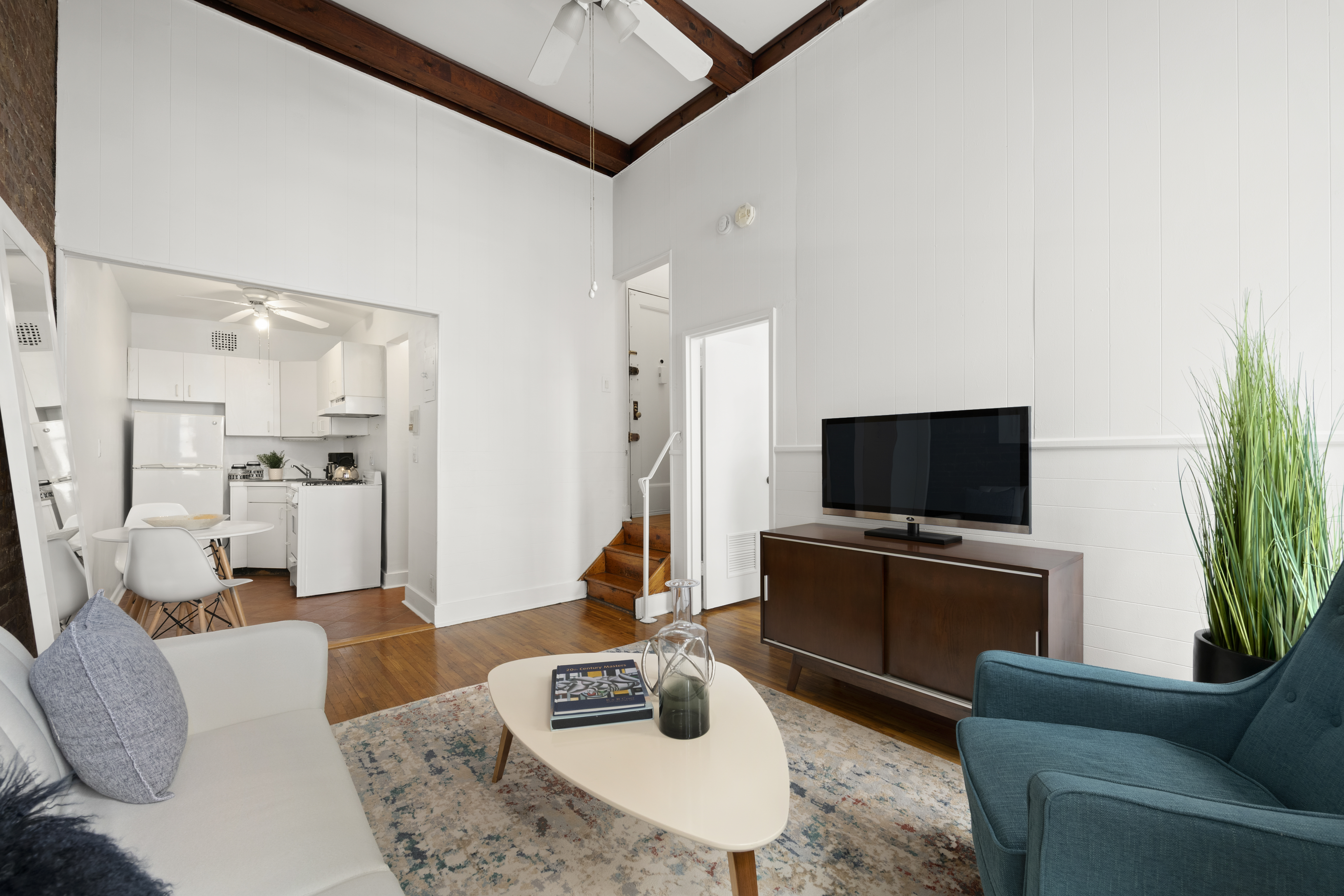 132 West 71st Street, Unit 3 Manhattan, NY 10023 - Photo 2 of 7 a living room with furniture and a flat screen tv