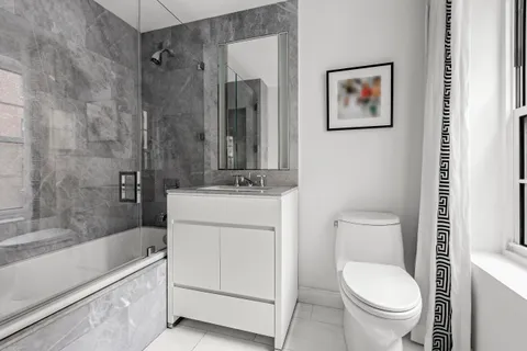 a bathroom with a toilet a sink and bathtub