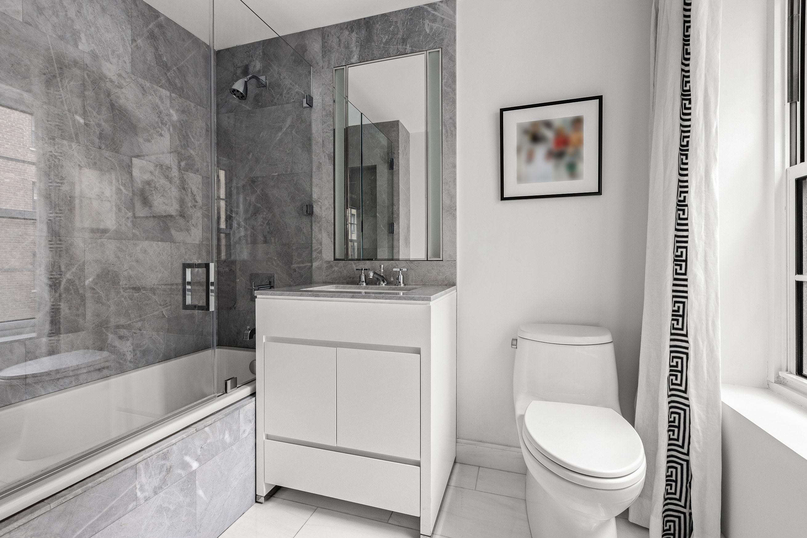12 East 88th Street, Unit 8A Manhattan, NY 10128 - Photo 11 of 19 a bathroom with a toilet a sink and bathtub