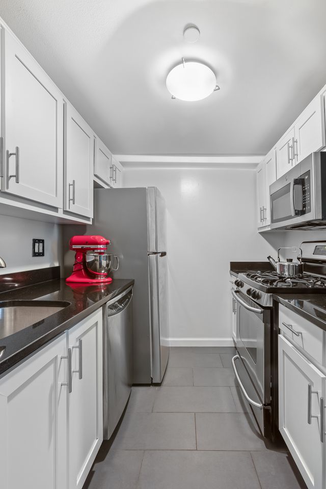 55 Poplar Street, Unit 2C Brooklyn, NY 11201 - Photo 4 of 14 a kitchen with stainless steel appliances granite countertop a sink stove and refrigerator