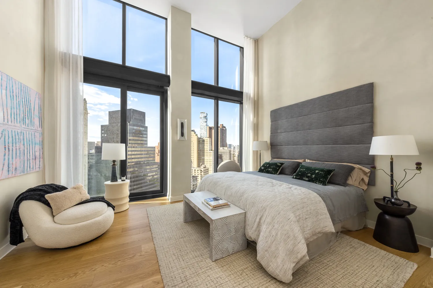 a bedroom with a bed and a large window