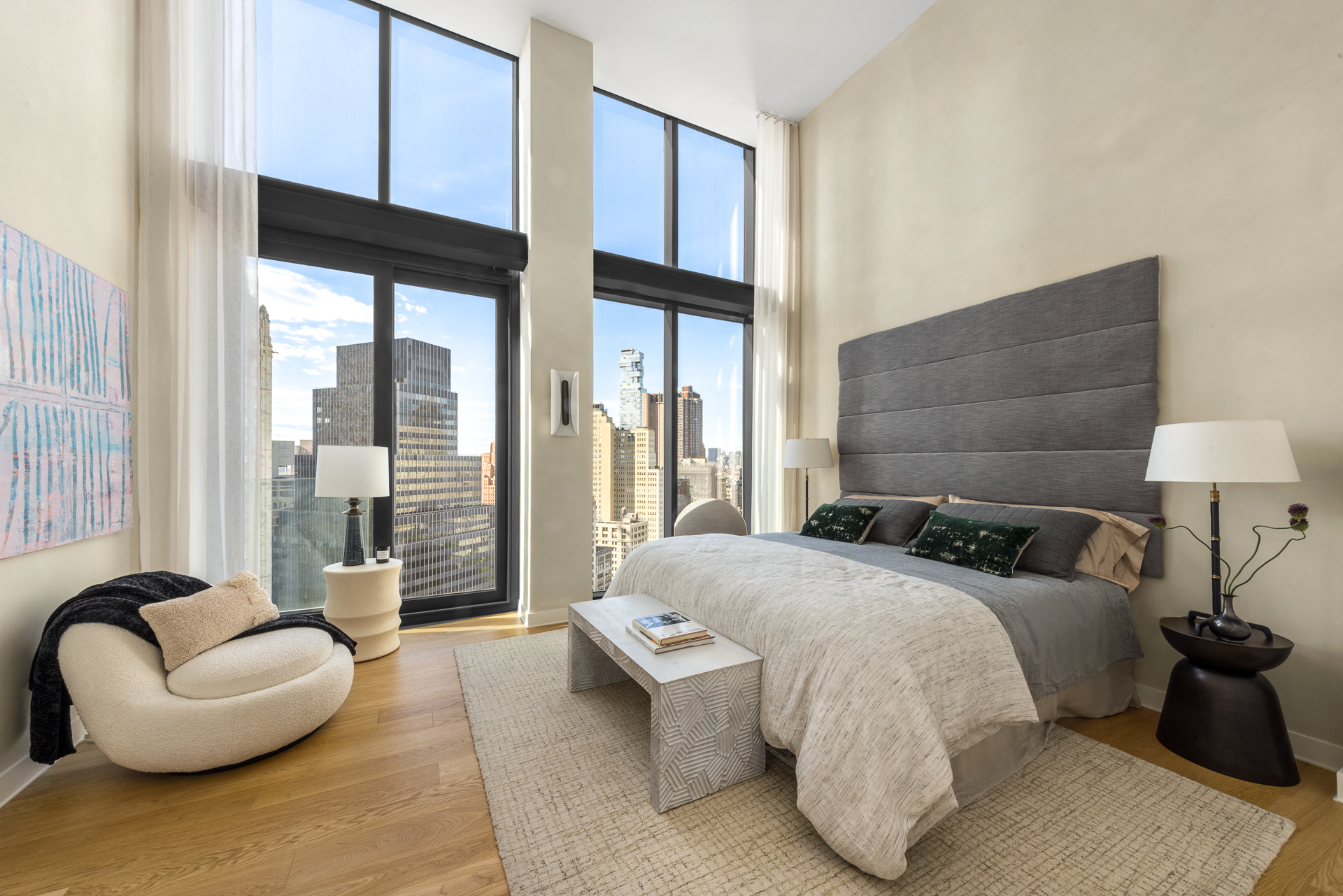 33 Park Row, Unit PH1 Manhattan, NY 10038 - Photo 9 of 15 a bedroom with a bed and a large window