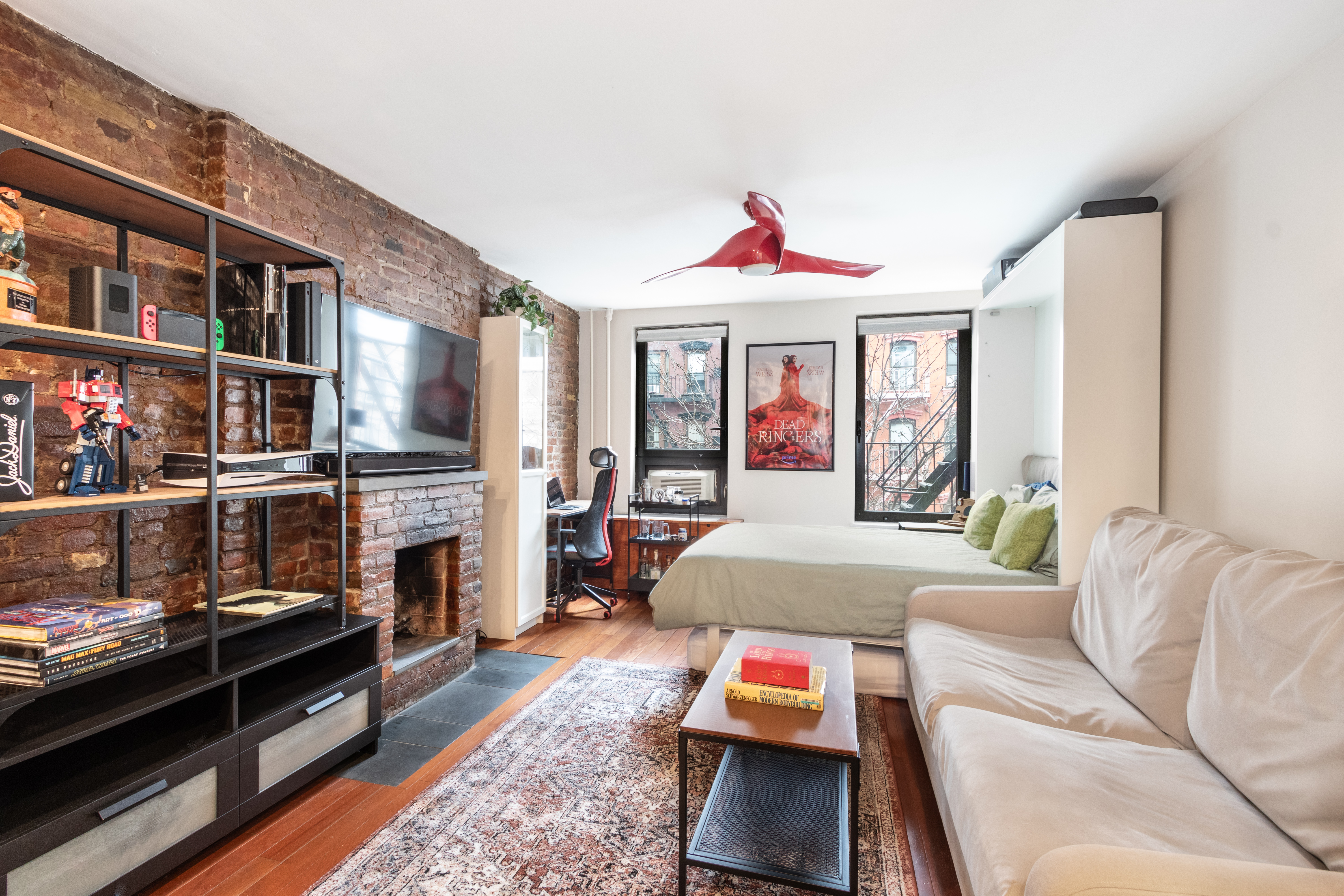 88 East 3rd Street, Unit 15 Manhattan, NY 10003 - Photo 1 of 6 a living room with furniture and a fireplace