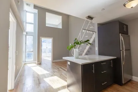 a bathroom with a granite countertop sink a mirror and a shower