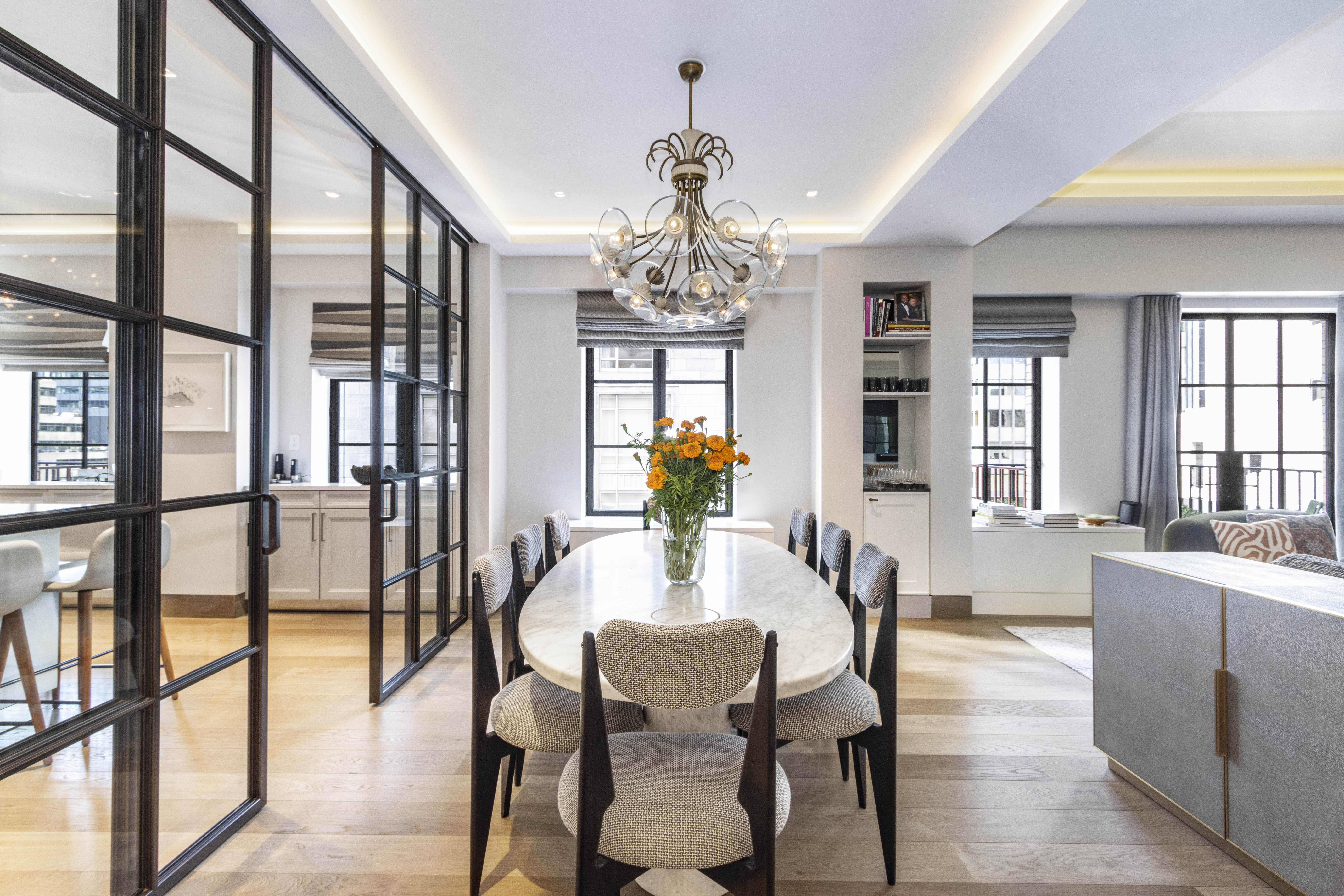40 East 61st Street, Unit 18A Manhattan, NY 10065 - Photo 3 of 15 a view of a dining room with furniture wooden floor and chandelier