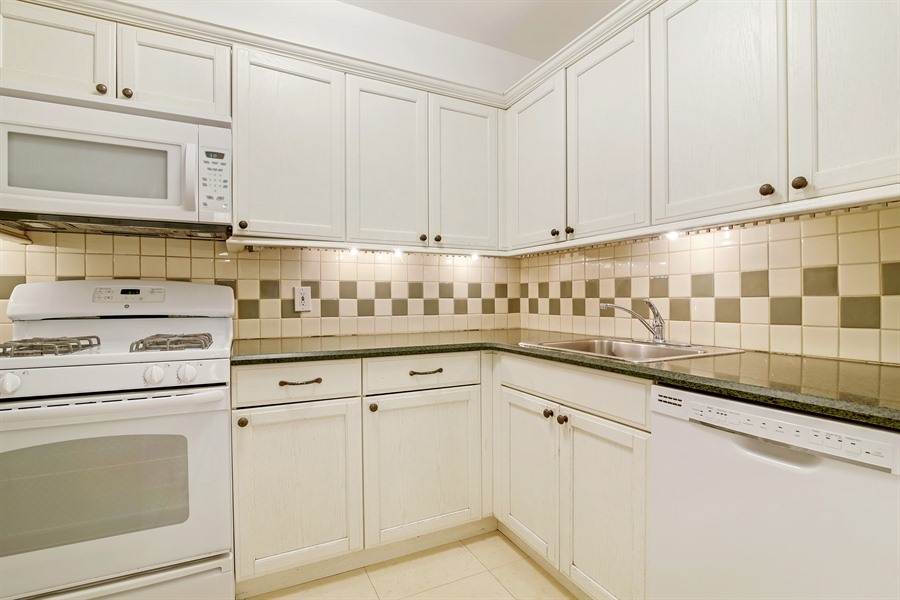 553 2nd Street, Unit 1 Brooklyn, NY 11215 - Photo 4 of 11 a kitchen with granite countertop white cabinets and white appliances