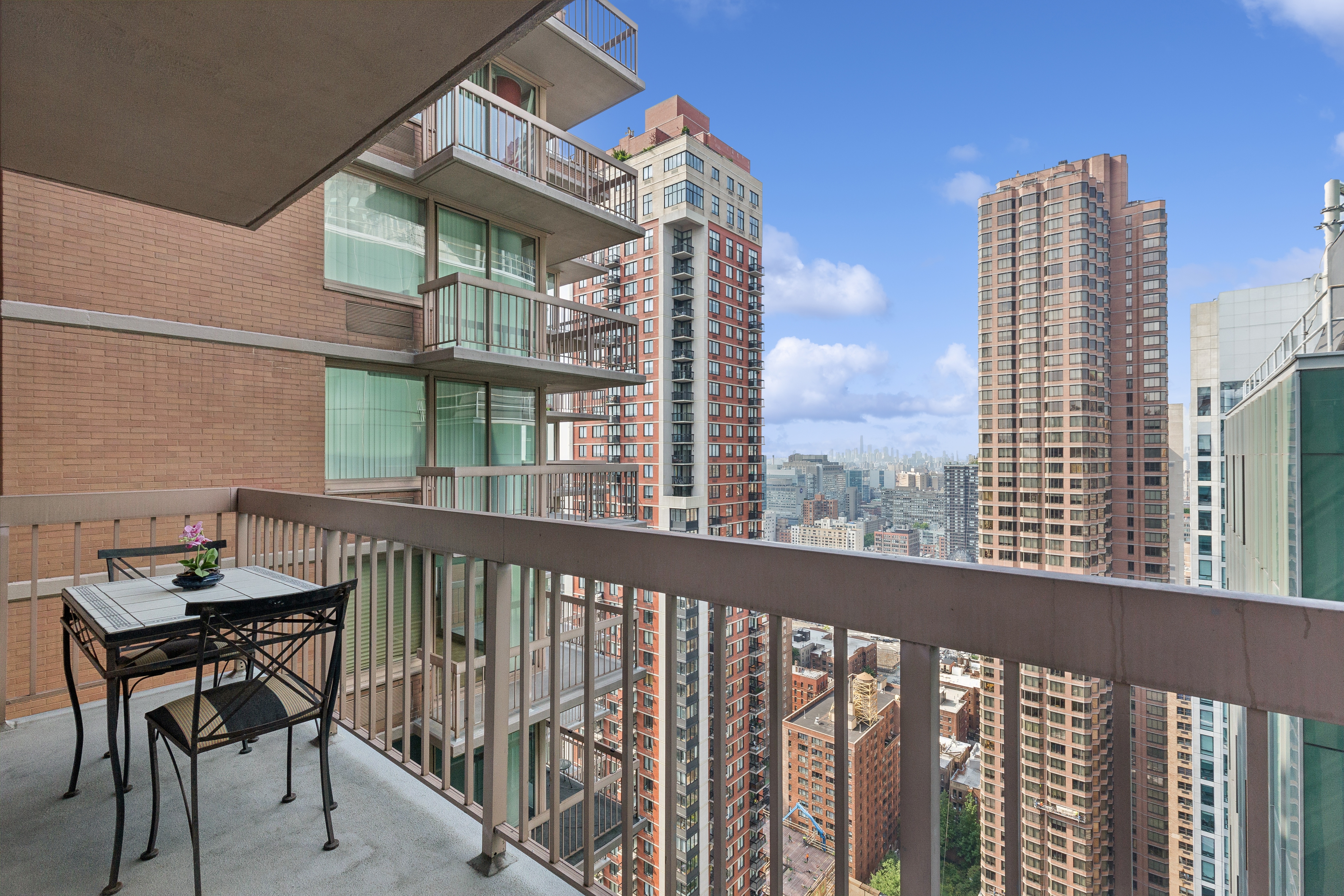 235 East 40th Street, Unit 37C Manhattan, NY 10016 - Photo 7 of 10 a view of a balcony with two chairs and a table