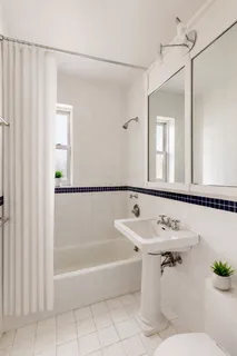 a bathroom with a sink mirror toilet and bathtub