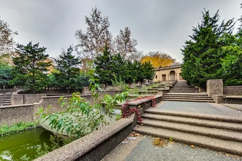a view of swimming pool with a patio and a garden