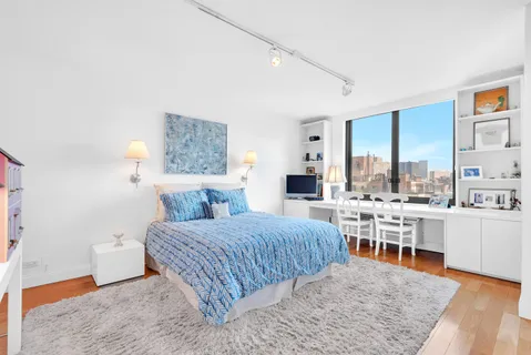 a room with a bed and a table in it