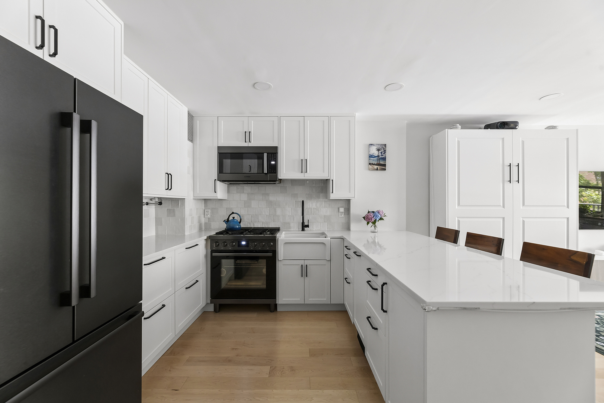 145 East 15th Street, Unit 2T Manhattan, NY 10003 - Photo 2 of 10 a large kitchen with stainless steel appliances double sink and a refrigerator