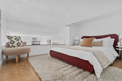 a bedroom with a bed and a couch