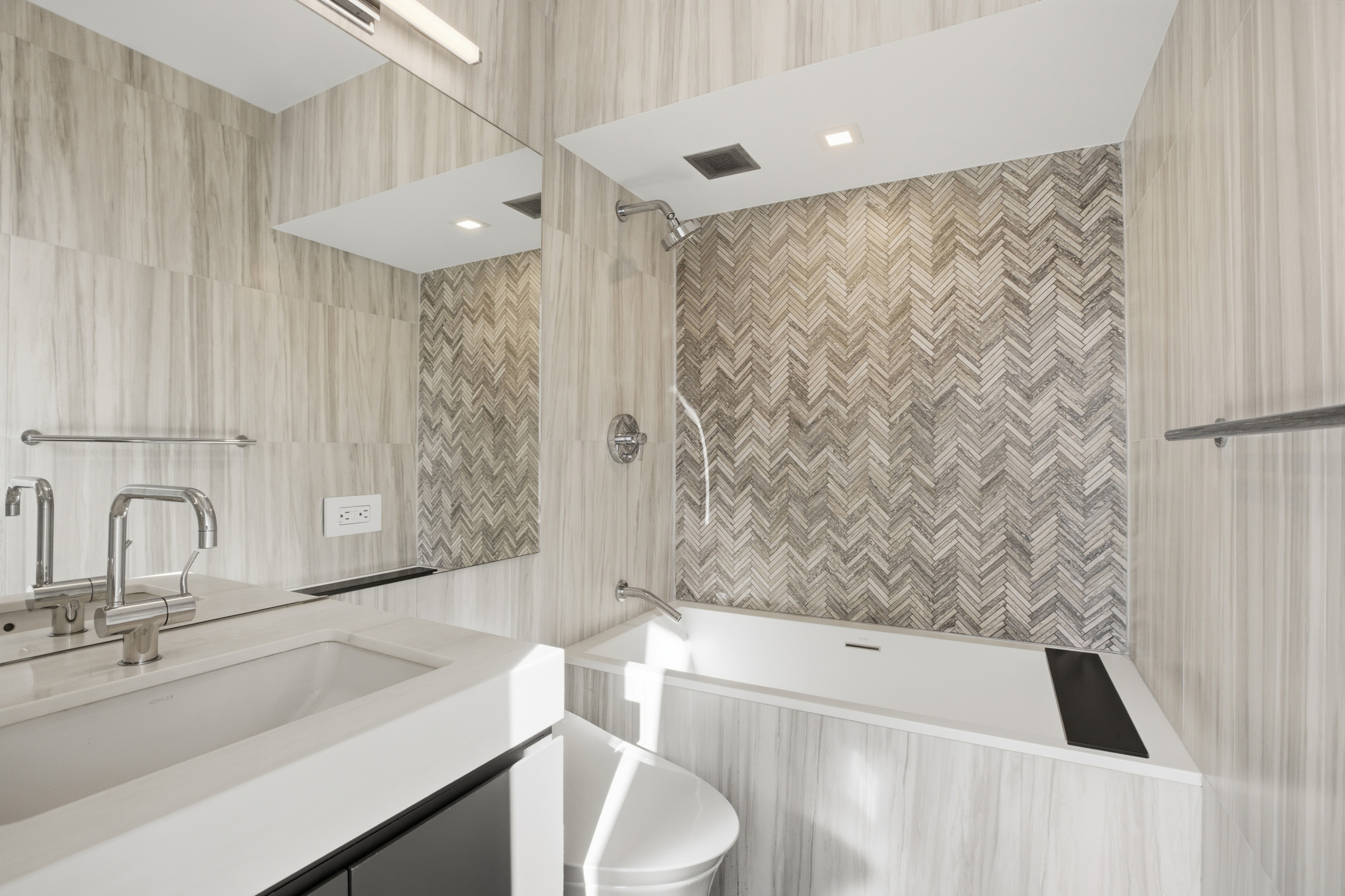309 East 49th Street, Unit 21A Manhattan, NY 10017 - Photo 12 of 18 a bathroom with a sink a toilet and a bathtub