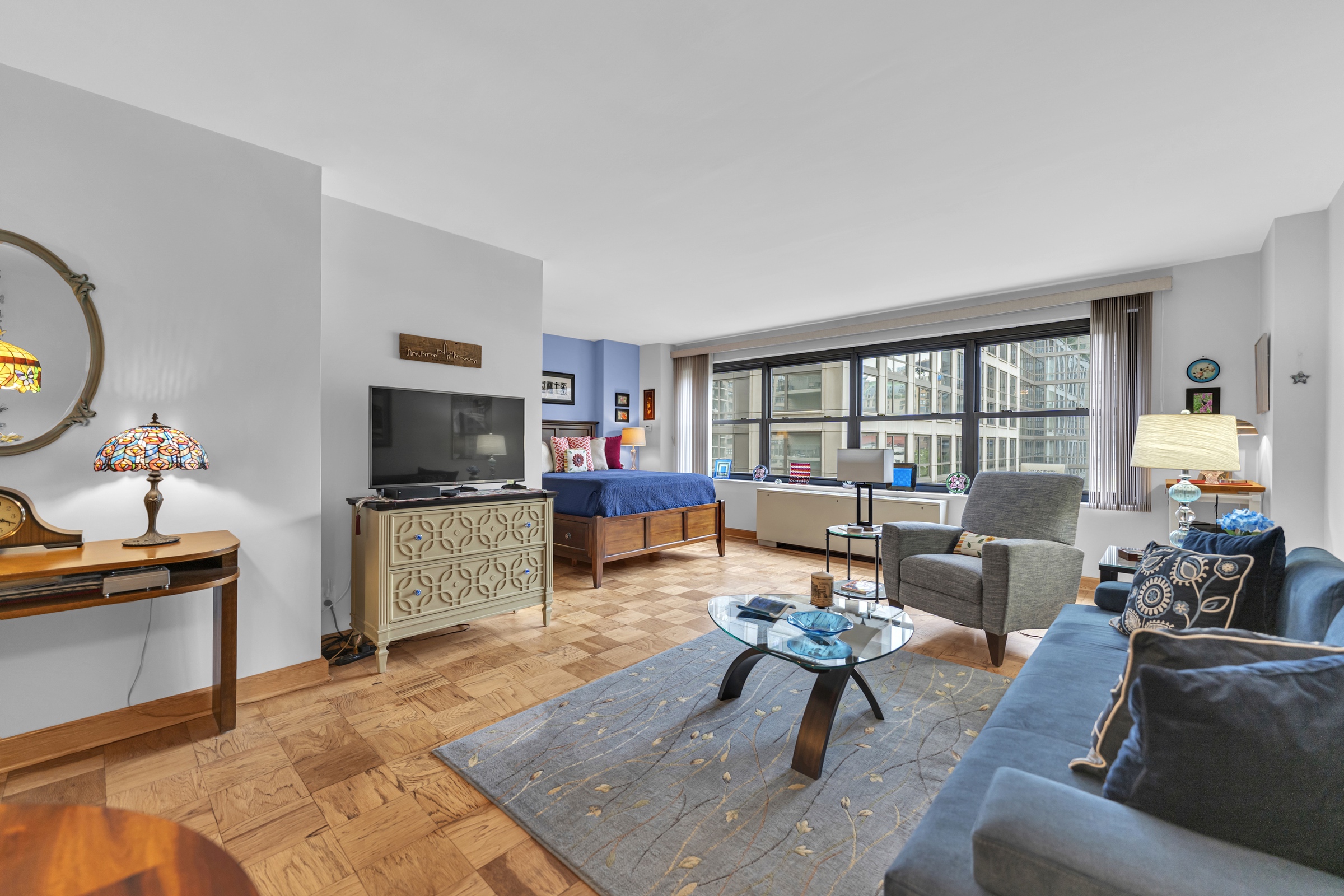 180 West End Avenue, Unit 9P Manhattan, NY 10023 - Photo 8 of 13 a living room with furniture and a flat screen tv