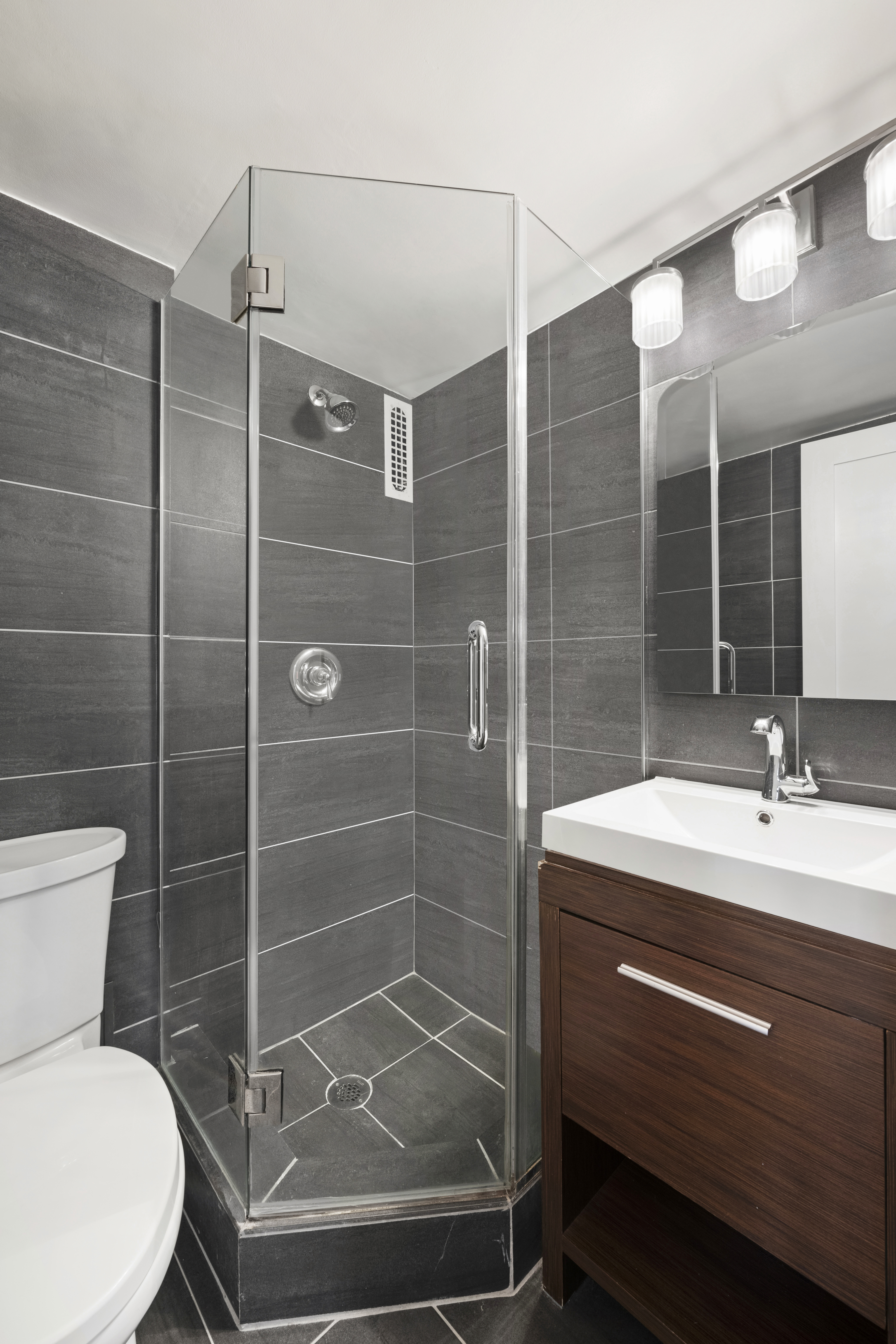 240 East 76th Street, Unit 2E Manhattan, NY 10021 - Photo 7 of 11 a bathroom with a sink toilet and shower