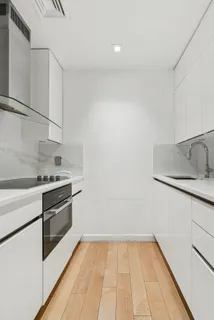 a kitchen with a sink cabinets and stainless steel appliances