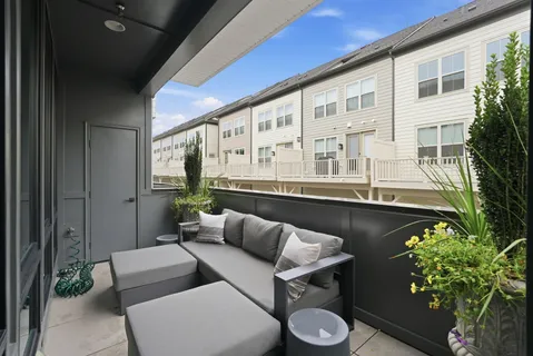 a balcony with furniture and flowers