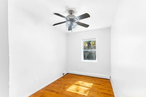 a view of a room with window and wooden floor