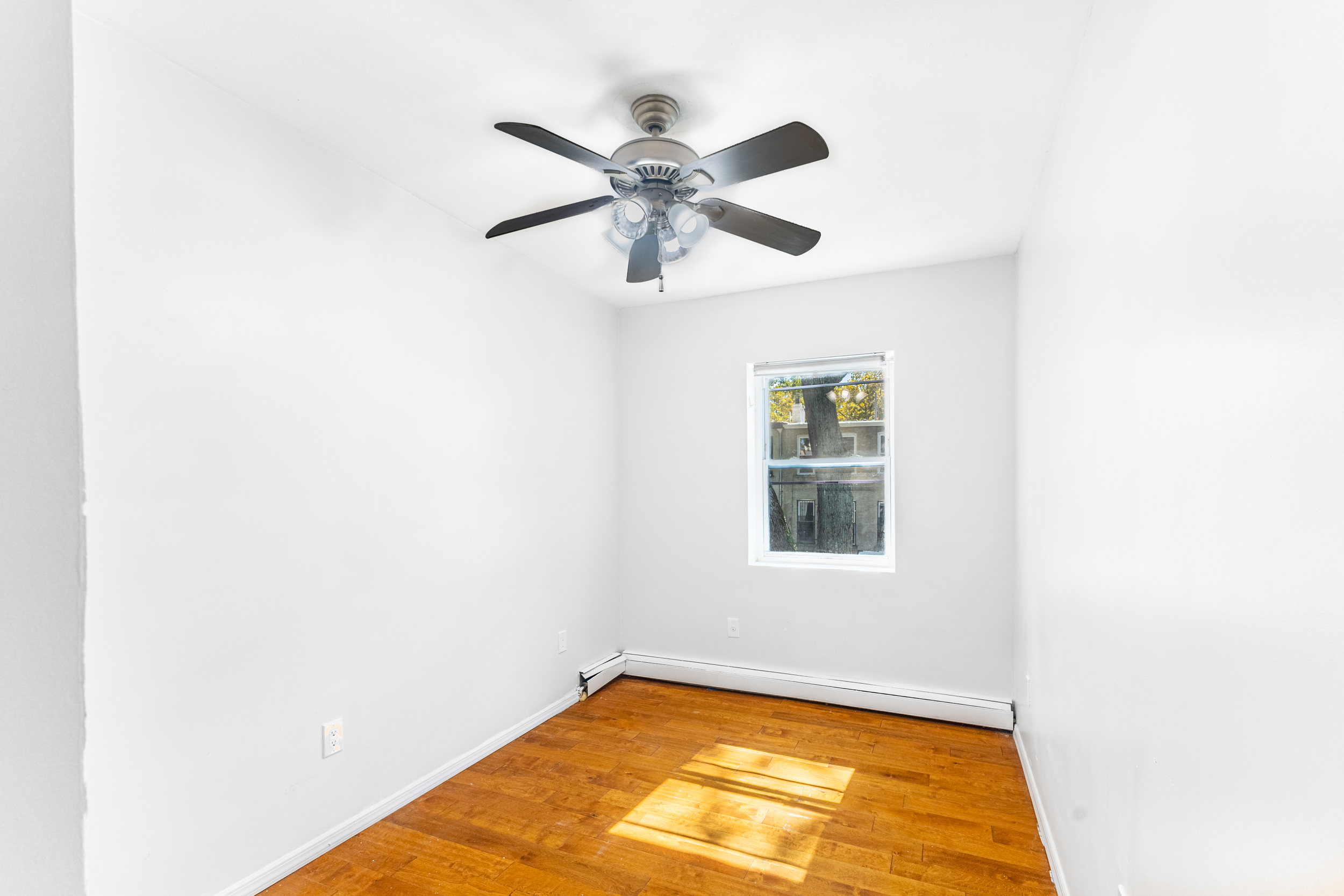 434 Lexington Avenue Brooklyn, NY 11221 - Photo 14 of 22 a view of a room with window and wooden floor
