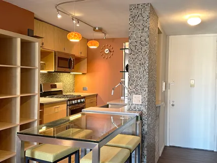 a kitchen with a refrigerator and a stove top oven