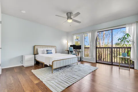 a spacious bedroom with a bed and a large window