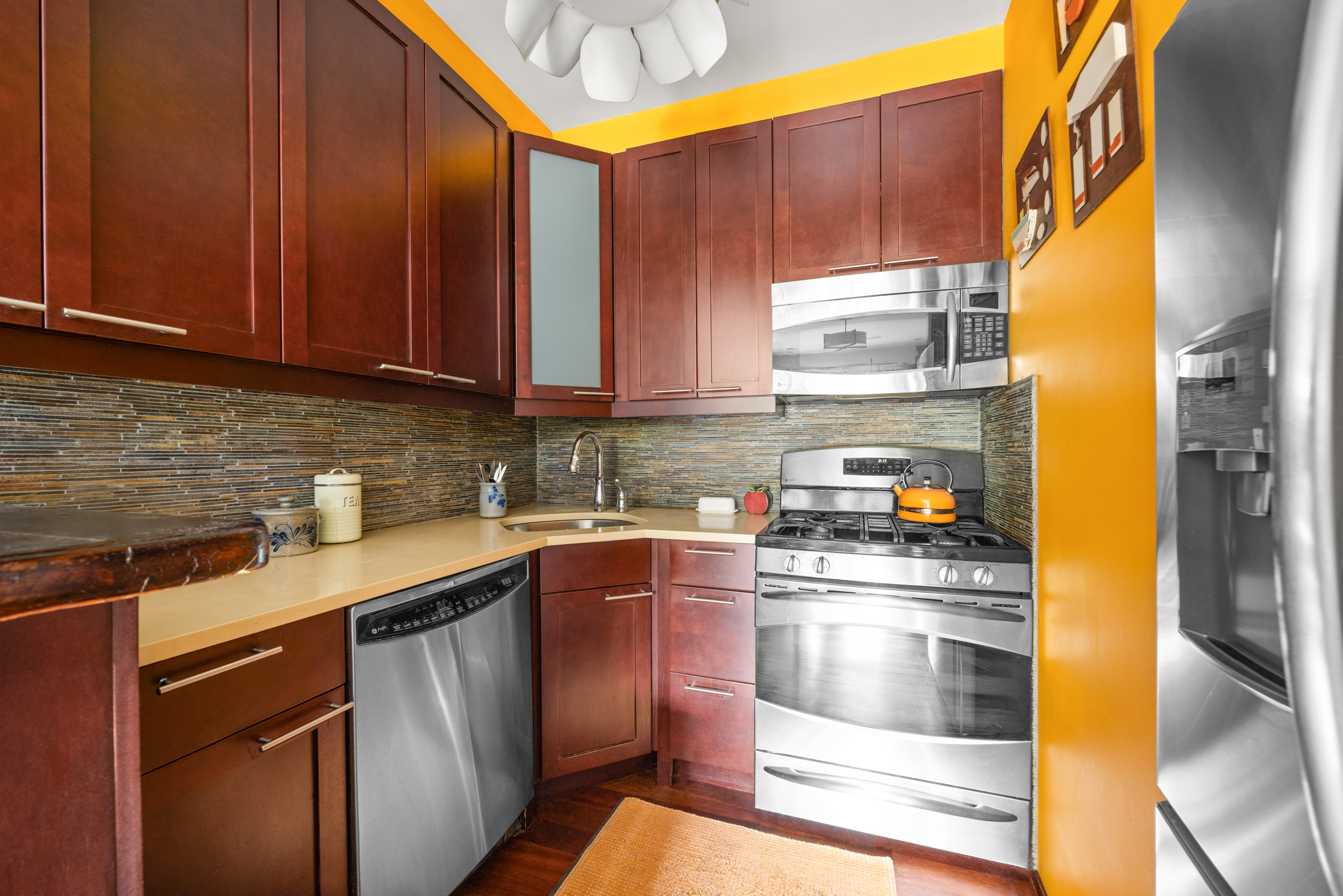 607 Manhattan Avenue, Unit 2 Brooklyn, NY 11222 - Photo 8 of 14 a kitchen with a sink a stove and cabinets