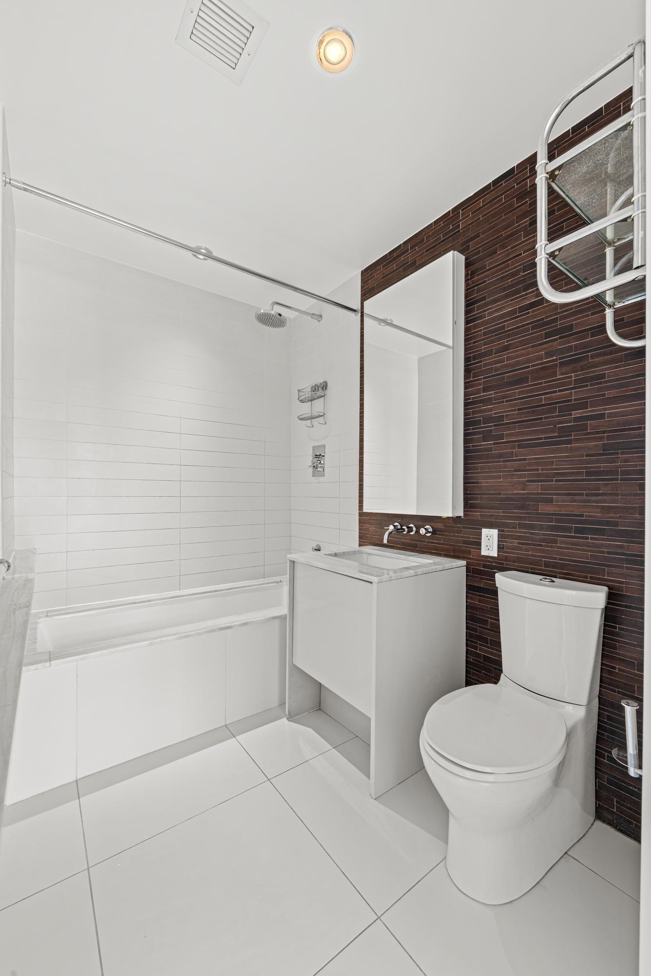 2 Northside Piers, Unit 30Y Brooklyn, NY 11249 - Photo 8 of 22 a bathroom with a toilet and a bathtub