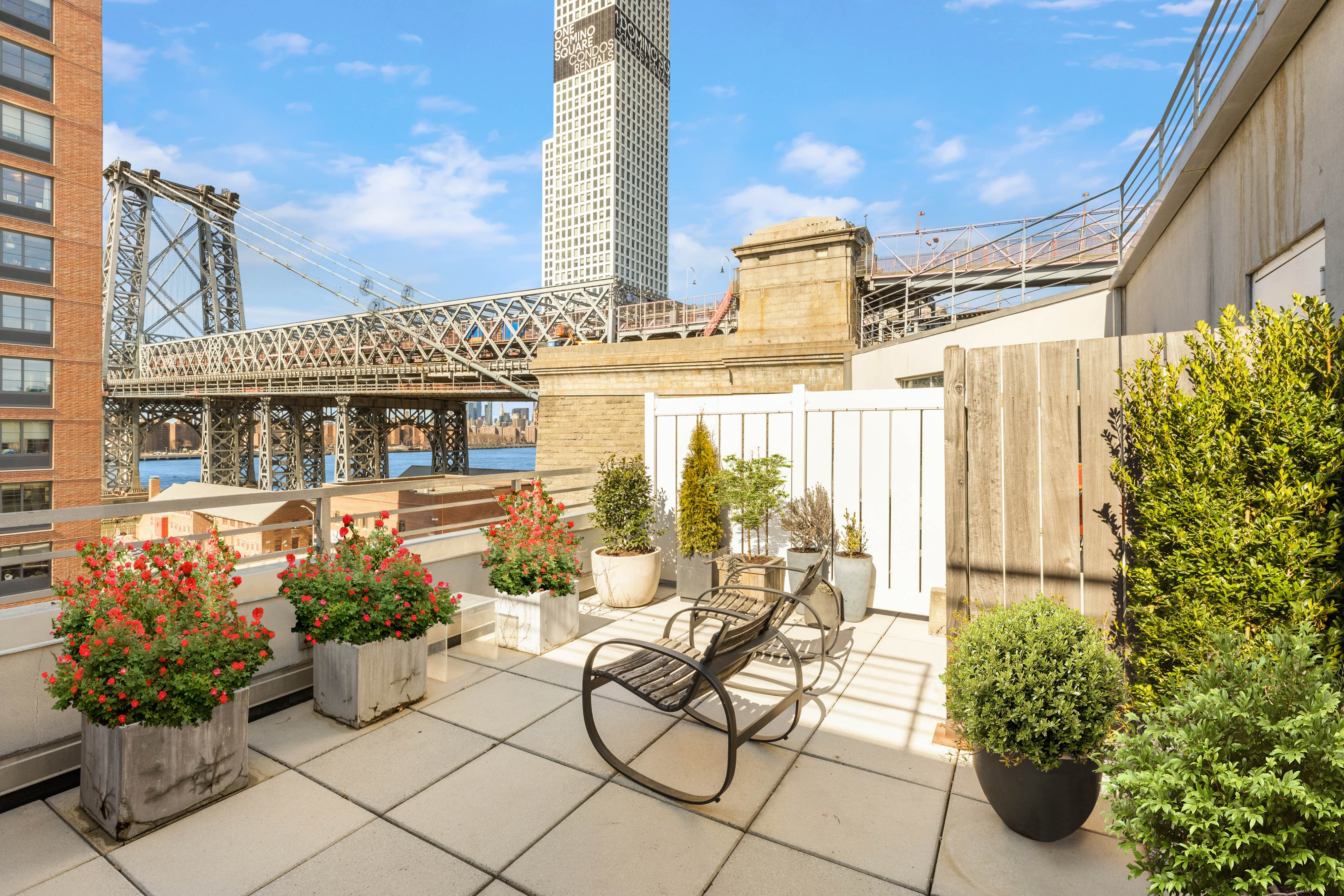 a view of a patio with chairs and potted plants