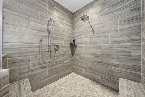 a bathroom with a toilet a sink and a large mirror