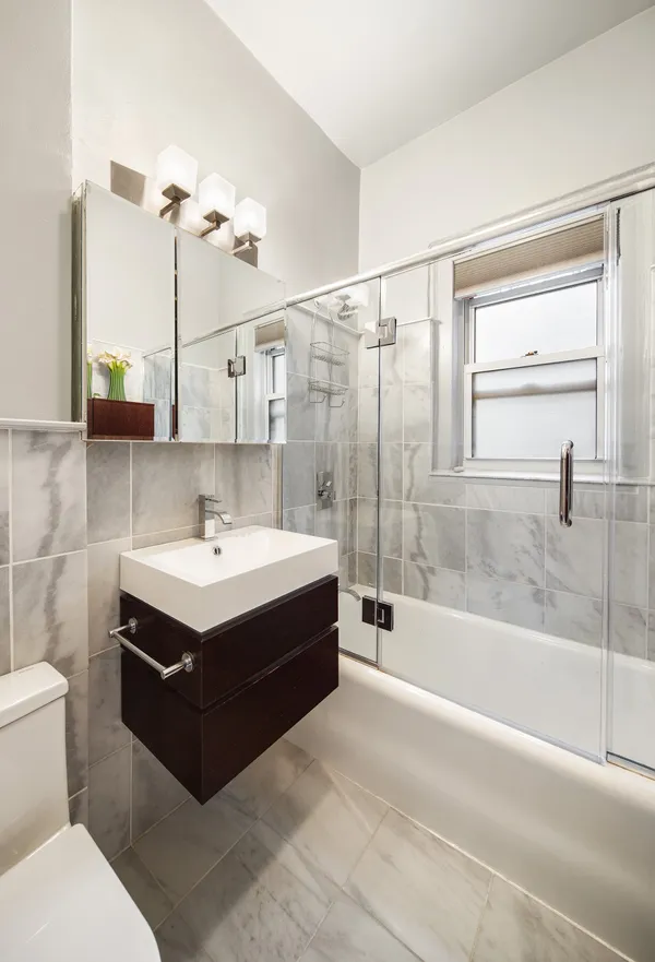 a white bath tub sitting next to a white sink