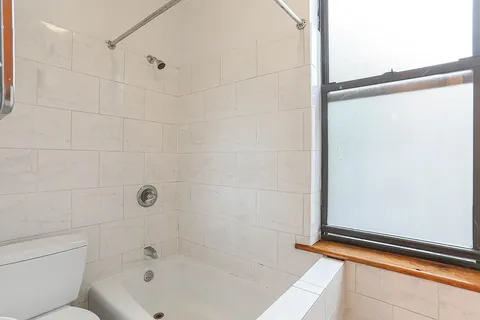 a bathroom with a bathtub and shower