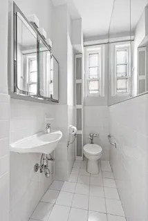 a bathroom with a sink a toilet and a mirror