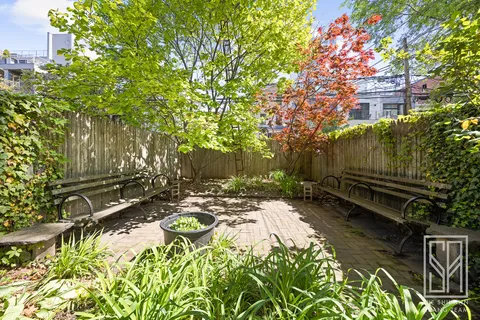 a backyard of a house with outdoor seating