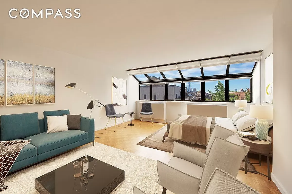 a living room with furniture and a window with garden view