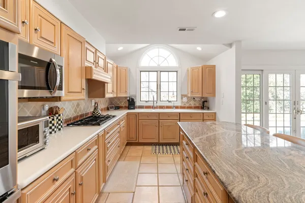 a bathroom with a granite countertop sink shower and a mirror