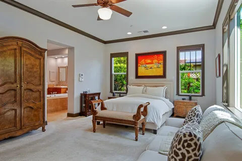 a bedroom with a bed and a chandelier