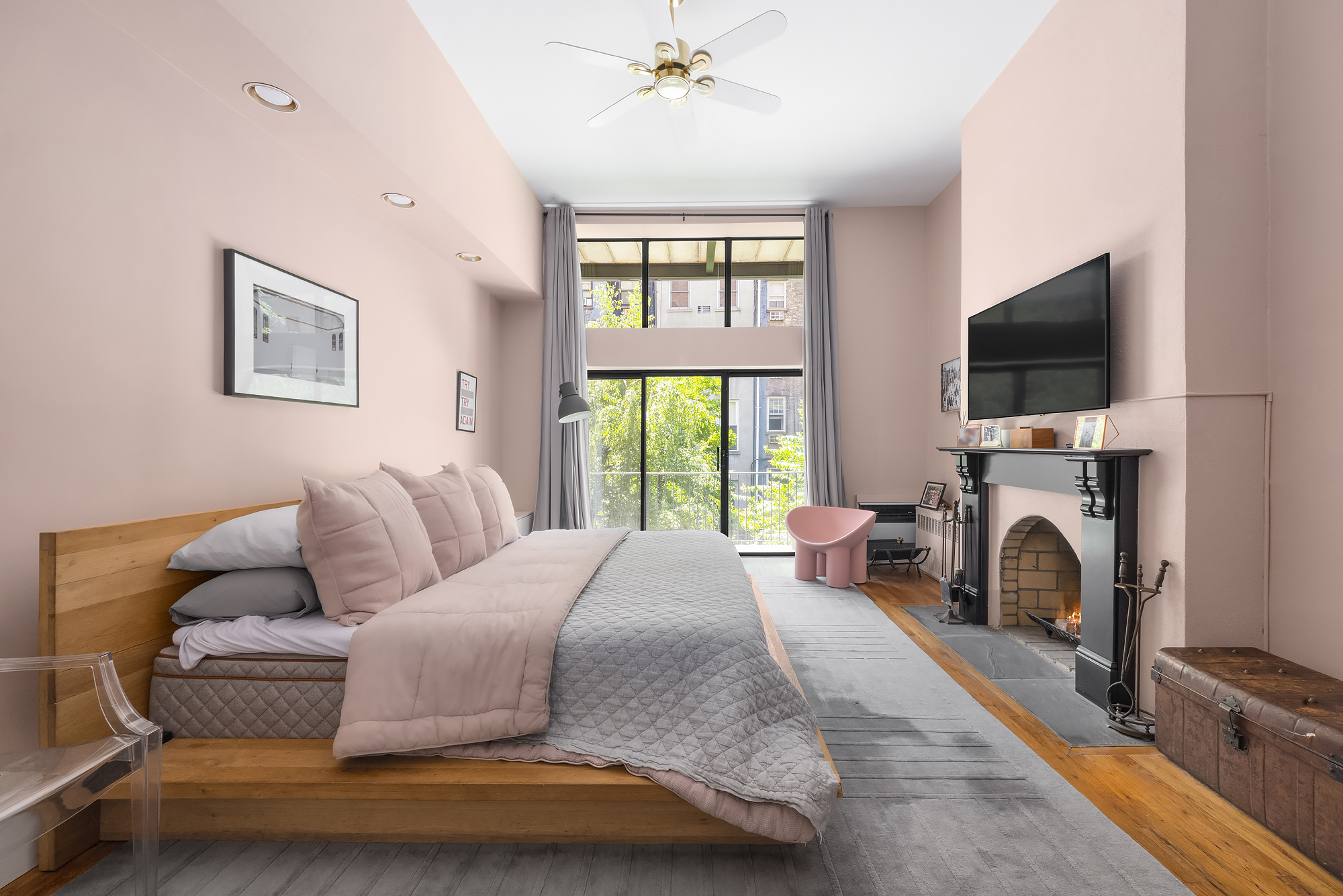 430 West 23rd Street, Unit C Manhattan, NY 10011 - Photo 11 of 16 a spacious bedroom with a bed and a flat screen tv