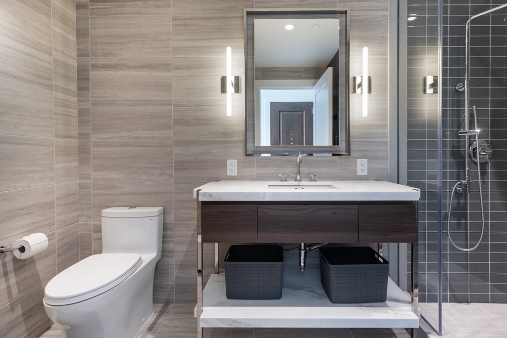 40 Trinity Place, Unit 1606 Boston, MA 02116 - Photo 10 of 17 a bathroom with a sink toilet and mirror